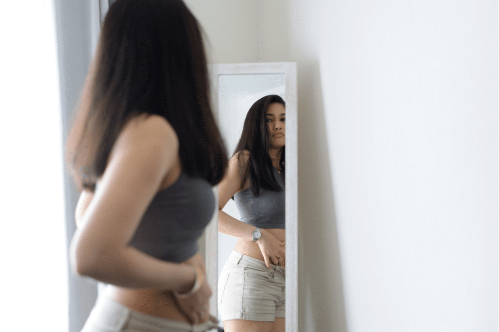 Teen girl looking in mirror