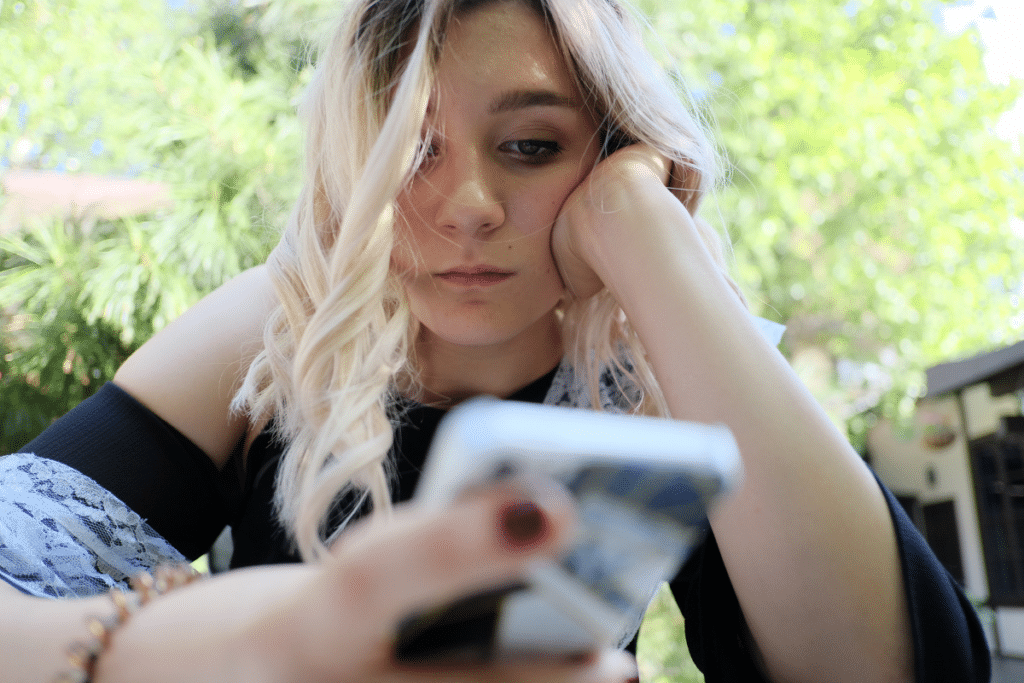 Teen girl staring at cell phone