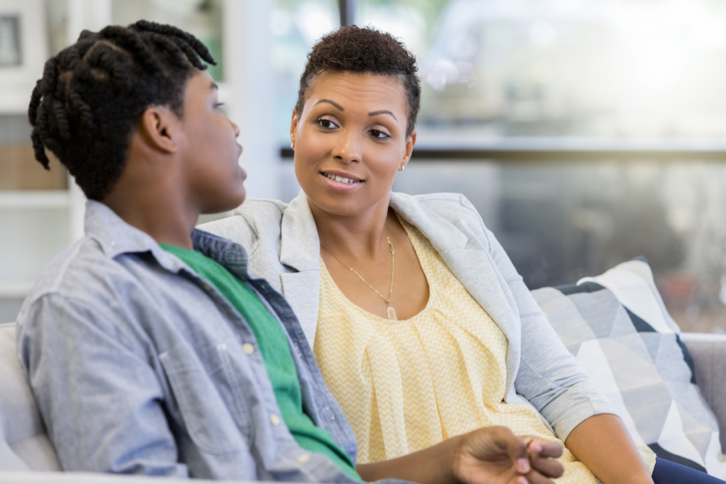 Parent talking with teen about self-esteem