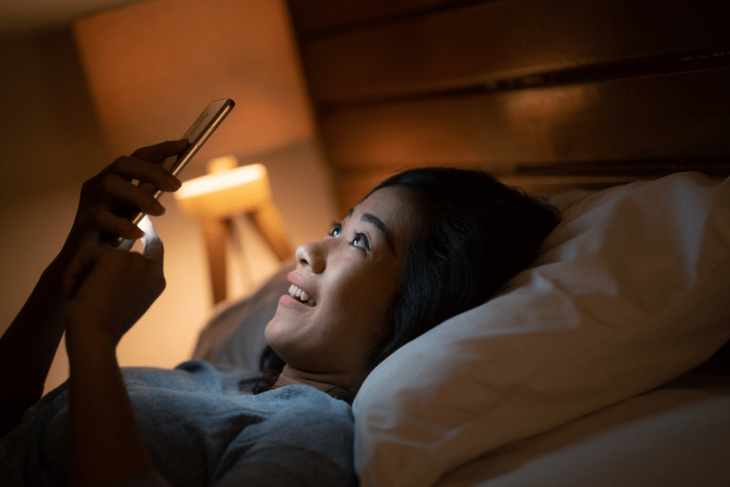 Teen girl using smartphone at bedtime