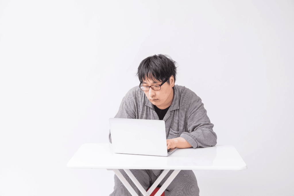 Person looking depressed while using their laptop