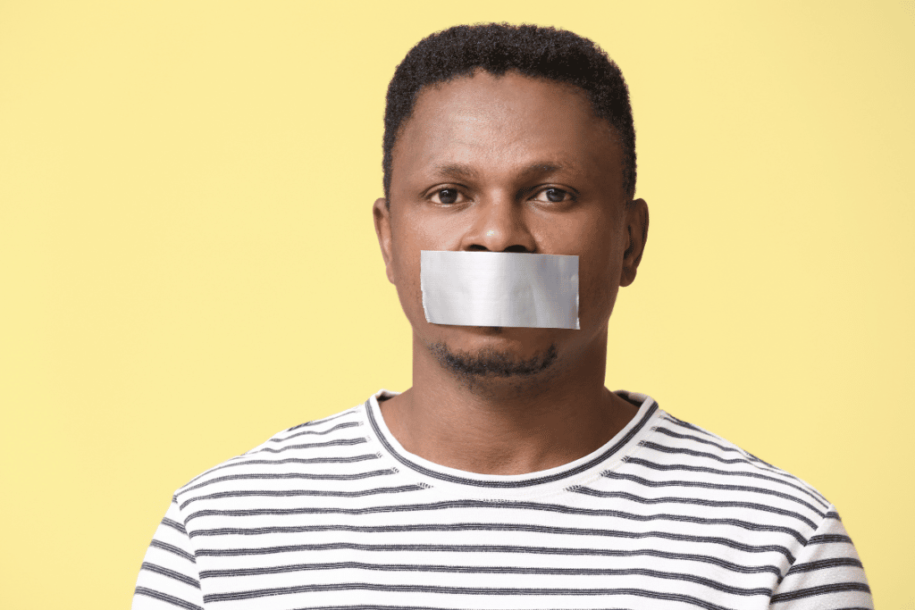 black man with tape covering mouth