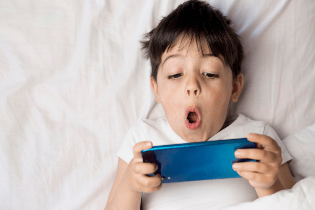 Child looking surprised while looking at phone