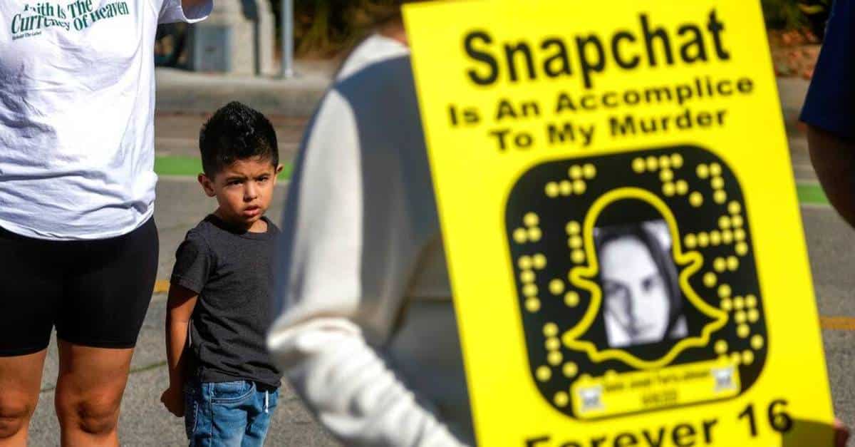 a person holding a sign protesting snapchat