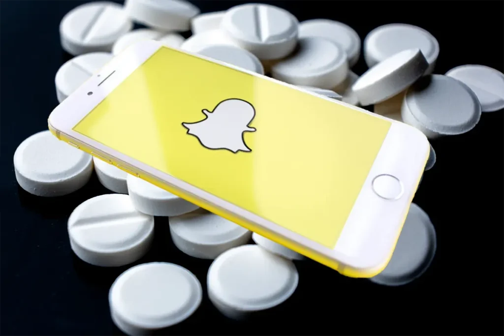 snapchat logo on a smartphone on pills