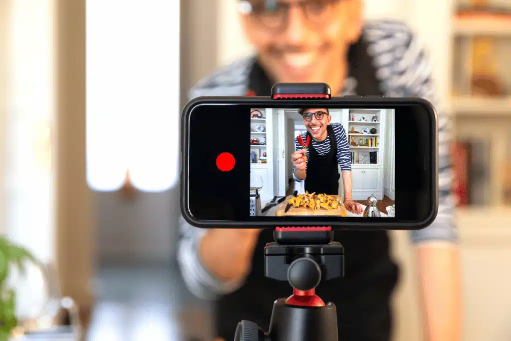 a man using a smartphone to film a video for social media