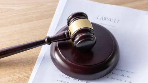 A Judge's gavel sitting on top a legal document.