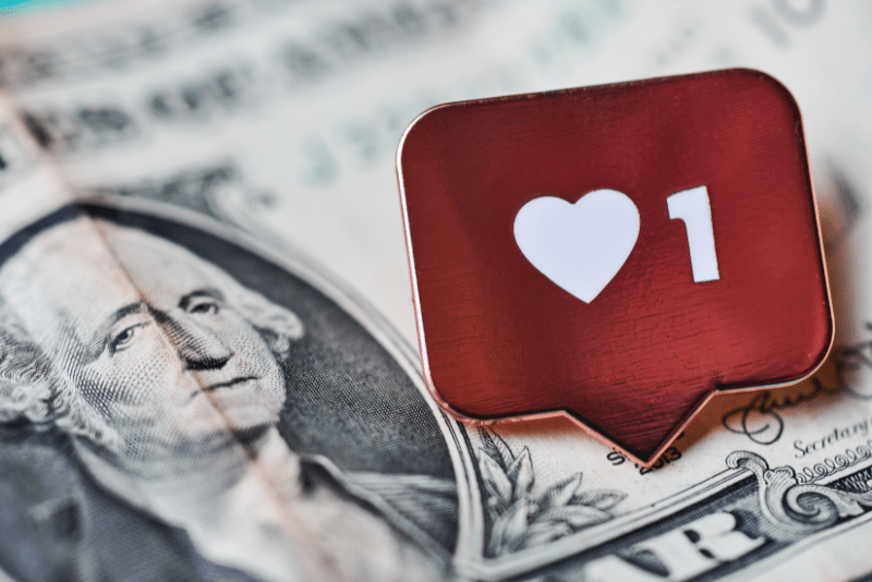 a photo of money and a social media heart icon