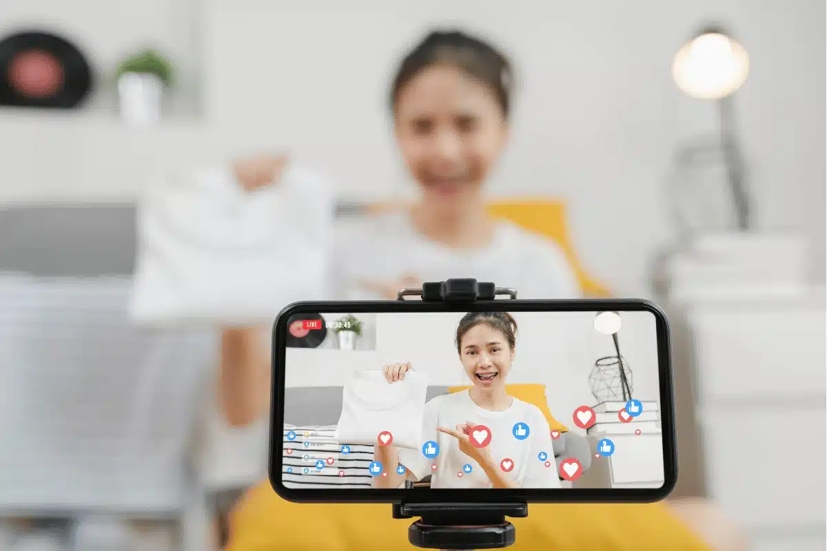 a teen girl shooting a video on her phone for social media