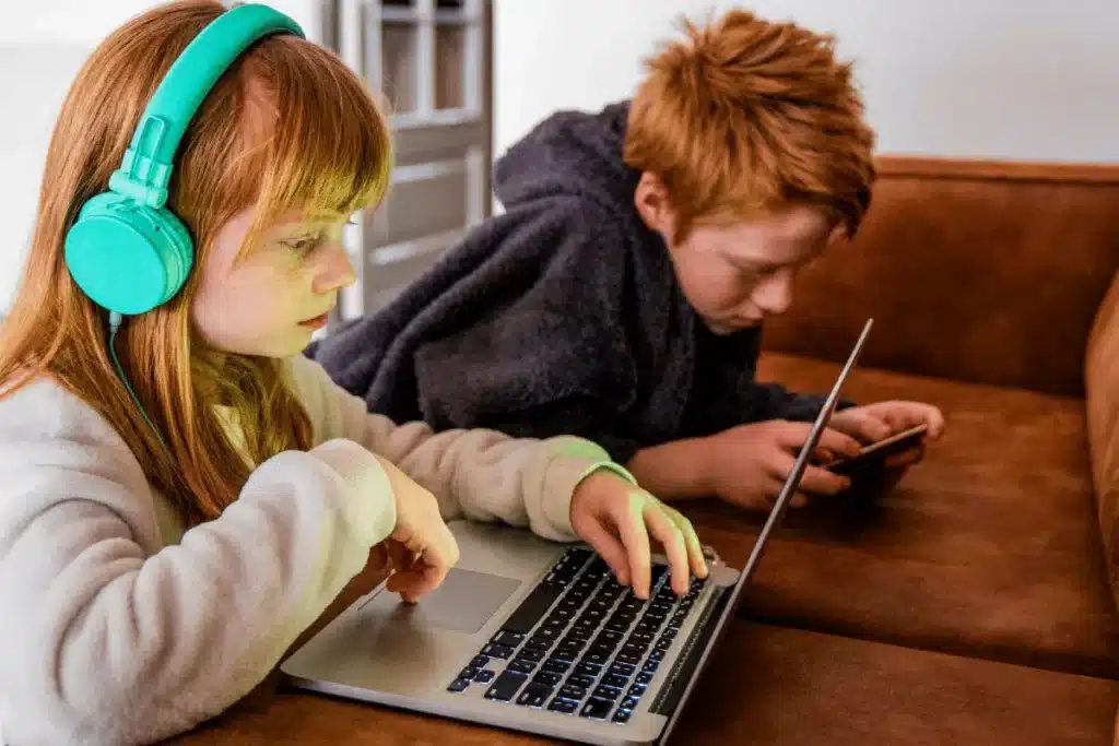 children using a laptop and smartphone