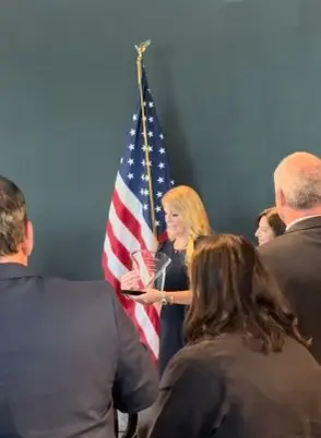 Jennie Deserio accepting the Woman of Distinction award for 2024