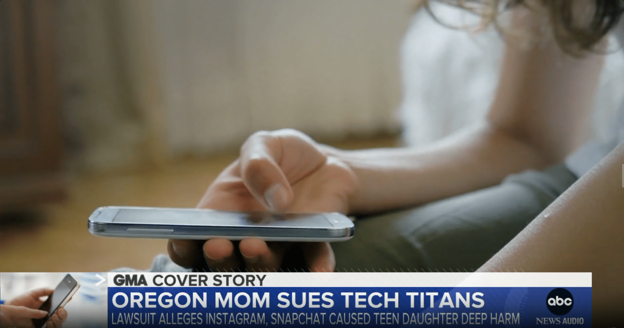 a teen using a phone on news coverage of an Oregon Mom suing tech companies