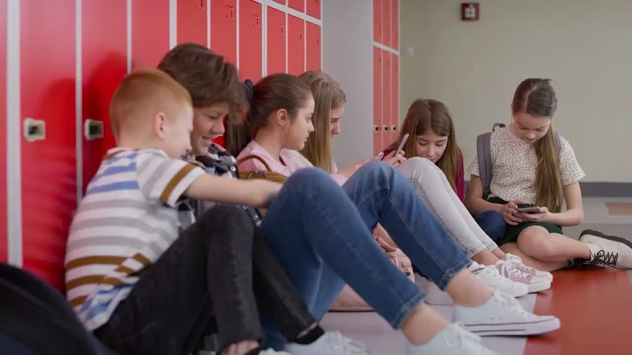 a group of teen using TikTok on their phones