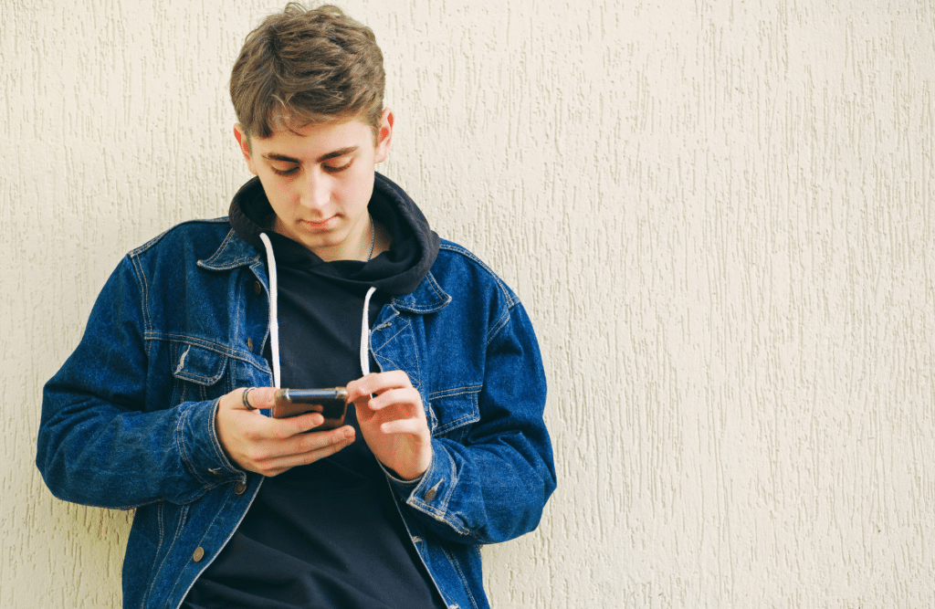 a teenager using social media on their phone