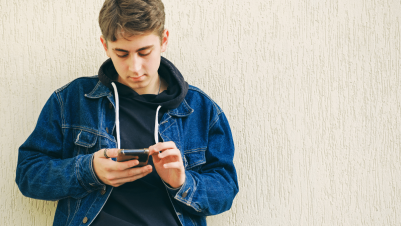 a teenager using social media on their phone